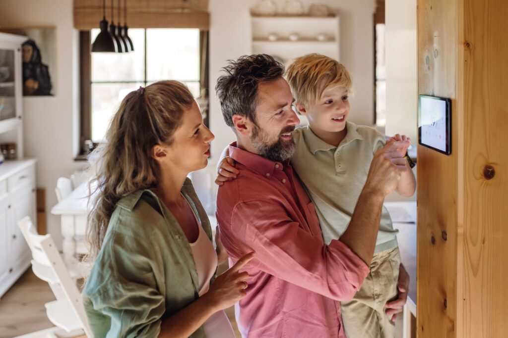 Familie nutzt Smart-Home-Steuerung für Fußbodenheizung.